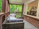View of screened porch with an outdoor sectional and views of the backyard, offering a relaxing retreat at 147 Olympic Pl, Decatur, GA 30030
