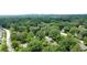 Overhead view of a home with the skyline in the distance beyond the tree line at 2107 Garden Cir, Decatur, GA 30032