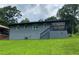 A view of the back of the house and the deck with stairs leading into the backyard at 2107 Garden Cir, Decatur, GA 30032