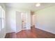 Sunlit bedroom boasts hardwood floors, ample natural light, and an open doorway to an ensuite bathroom at 2107 Garden Cir, Decatur, GA 30032