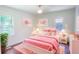 Cozy bedroom featuring hardwood floors, a ceiling fan, and a large window with natural light at 2107 Garden Cir, Decatur, GA 30032