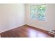 Empty room showing hardwood floors, white trim, and a window overlooking foliage at 2107 Garden Cir, Decatur, GA 30032