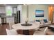 Bright dining area featuring a round table, modern lighting, and adjacent living space with comfortable seating at 2107 Garden Cir, Decatur, GA 30032