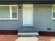 Close up of front door entrance with painted steps, brickwork and sidelight window at 2107 Garden Cir, Decatur, GA 30032