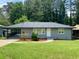 Charming gray home features a lush, well-manicured lawn and welcoming entrance with tasteful landscaping at 2107 Garden Cir, Decatur, GA 30032
