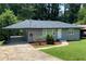 Charming gray home features a lush, well-manicured lawn and welcoming entrance with tasteful landscaping at 2107 Garden Cir, Decatur, GA 30032