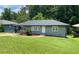 Charming gray home features a lush, well-manicured lawn and welcoming entrance with tasteful landscaping at 2107 Garden Cir, Decatur, GA 30032
