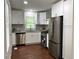 Modern kitchen with stainless steel appliances, white cabinets, and hardwood floors at 2107 Garden Cir, Decatur, GA 30032