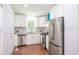 Modern kitchen featuring white cabinets, stainless steel appliances, and hardwood floors at 2107 Garden Cir, Decatur, GA 30032