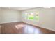 Spacious living room with hardwood floors, bright windows, and a white door at 2107 Garden Cir, Decatur, GA 30032