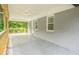 Covered porch with a view of the backyard, painted brick and wood railings at 2107 Garden Cir, Decatur, GA 30032