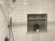 Close-up of shower with subway tile, a built-in niche, and modern fixtures at 2107 Garden Cir, Decatur, GA 30032