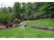 Spacious backyard featuring a lush lawn, mature trees, and attractive landscaping at 1997 Shaker Falls Ln, Lawrenceville, GA 30045