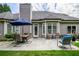 Backyard with a patio, outdoor seating, a table with umbrella, and lush green lawn at 1997 Shaker Falls Ln, Lawrenceville, GA 30045