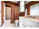 Traditional bathroom with a shower-tub combo, white vanity, and a bright window at 1997 Shaker Falls Ln, Lawrenceville, GA 30045