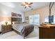 Comfortable bedroom with neutral carpet, fan and a large window for natural light at 1997 Shaker Falls Ln, Lawrenceville, GA 30045