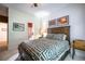 Bedroom featuring a wooden bed frame, patterned bedding, and warm lighting for a cozy ambiance at 1997 Shaker Falls Ln, Lawrenceville, GA 30045