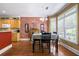 Charming dining area with a brick accent wall adjacent to a modern kitchen at 1997 Shaker Falls Ln, Lawrenceville, GA 30045