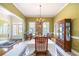 Bright dining room with large windows, chandelier, and doorway to living room at 1997 Shaker Falls Ln, Lawrenceville, GA 30045