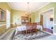 Bright dining room featuring a chandelier, decorative rug and ample space for entertaining at 1997 Shaker Falls Ln, Lawrenceville, GA 30045