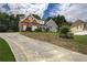Beautiful home with a long driveway, lush lawn, and manicured landscaping at 1997 Shaker Falls Ln, Lawrenceville, GA 30045