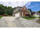 Charming home featuring a large driveway and well-maintained landscaping at 1997 Shaker Falls Ln, Lawrenceville, GA 30045