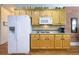 Bright kitchen with light wood cabinets, stainless steel appliances, and granite countertops at 1997 Shaker Falls Ln, Lawrenceville, GA 30045