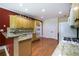 Spacious kitchen with wooden floors, granite countertops, and stainless steel appliances at 1997 Shaker Falls Ln, Lawrenceville, GA 30045