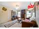 Cozy living room with a ceiling fan, carpet, and vintage industrial decor with a brown couch at 1997 Shaker Falls Ln, Lawrenceville, GA 30045