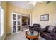 Sitting Room with doll display, large window, and an entrance to the dining room at 1997 Shaker Falls Ln, Lawrenceville, GA 30045