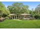 Spacious backyard with lush lawn, mature trees, large deck, and beautiful landscaping at 2481 Melinda Ne Dr, Atlanta, GA 30345