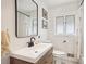 Cozy bathroom featuring a black framed mirror, modern sink, and floral shower curtain at 2481 Melinda Ne Dr, Atlanta, GA 30345