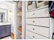Organized closet with drawers and shelving, adjacent to bathroom with vanity at 2481 Melinda Ne Dr, Atlanta, GA 30345
