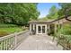 Large wooden deck with outdoor seating and lush green surroundings at 2481 Melinda Ne Dr, Atlanta, GA 30345