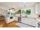 Open kitchen with white cabinets, granite countertops, stainless appliances, and view to dining area at 2481 Melinda Ne Dr, Atlanta, GA 30345
