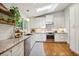 Bright kitchen featuring white cabinets, granite countertops, stainless steel appliances, and a skylight at 2481 Melinda Ne Dr, Atlanta, GA 30345