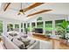Bright living room featuring hardwood floors, skylights, a ceiling fan, and backyard views at 2481 Melinda Ne Dr, Atlanta, GA 30345