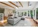 Open concept living area featuring hardwood floors, exposed beams, and views to the dining room at 2481 Melinda Ne Dr, Atlanta, GA 30345