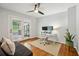 Bright office space featuring hardwood floors, ceiling fan, modern desk, and sliding glass doors to the outside at 2481 Melinda Ne Dr, Atlanta, GA 30345