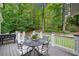 Charming back deck featuring an outdoor dining set and views of the private backyard at 4333 Collingham Ne Trce, Marietta, GA 30068