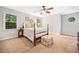 Comfortable bedroom featuring a ceiling fan, area rug, and two windows providing natural light at 4333 Collingham Ne Trce, Marietta, GA 30068