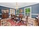 Elegant dining room with blue walls, hardwood floors, and a beautiful chandelier at 4333 Collingham Ne Trce, Marietta, GA 30068