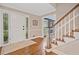 Inviting foyer with hardwood floors, staircase, and view into another living area at 4333 Collingham Ne Trce, Marietta, GA 30068