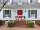 Close up of front entry with bright red door and brick stairs, complemented by manicured bushes at 4333 Collingham Ne Trce, Marietta, GA 30068