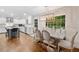 Open concept kitchen and dining area with modern light fixture, white cabinets, and hardwood floors at 4333 Collingham Ne Trce, Marietta, GA 30068