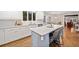 Elegant kitchen featuring white cabinets, marble countertops, and a large island with bar stools at 4333 Collingham Ne Trce, Marietta, GA 30068