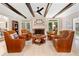Comfortable living room with a fireplace, wood beams, and a seating arrangement for gatherings at 4333 Collingham Ne Trce, Marietta, GA 30068