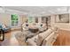 Bright living room featuring coffered ceilings, hardwood floors, and large windows with a corner sectional sofa at 4333 Collingham Ne Trce, Marietta, GA 30068