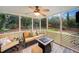 Inviting screened porch features a ceiling fan, outdoor seating, and view of the lush backyard at 4333 Collingham Ne Trce, Marietta, GA 30068
