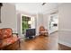 Cozy sitting room featuring hardwood floors, window shutters, and view into the kitchen at 4333 Collingham Ne Trce, Marietta, GA 30068